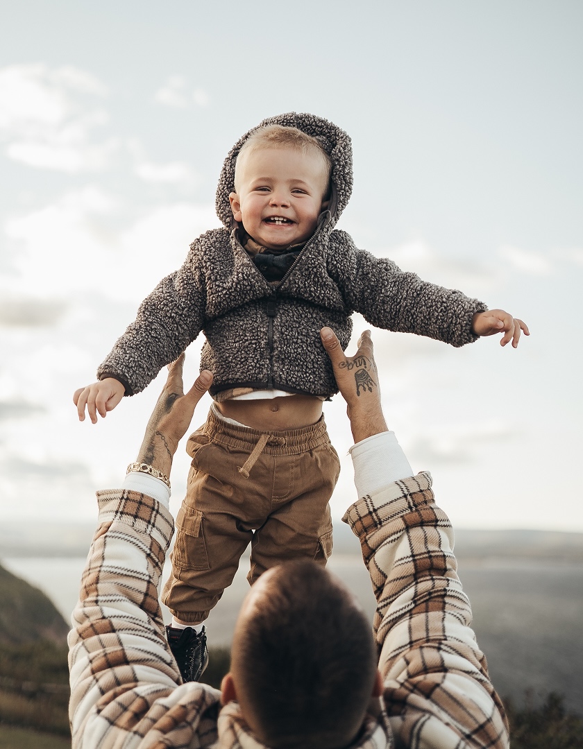 Photo d'un homme portant un enfant à bout de bras